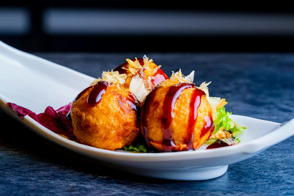 pexels-photo-28460875-28460875 Delicious Takoyaki Balls with Sauce on Elegant Plate