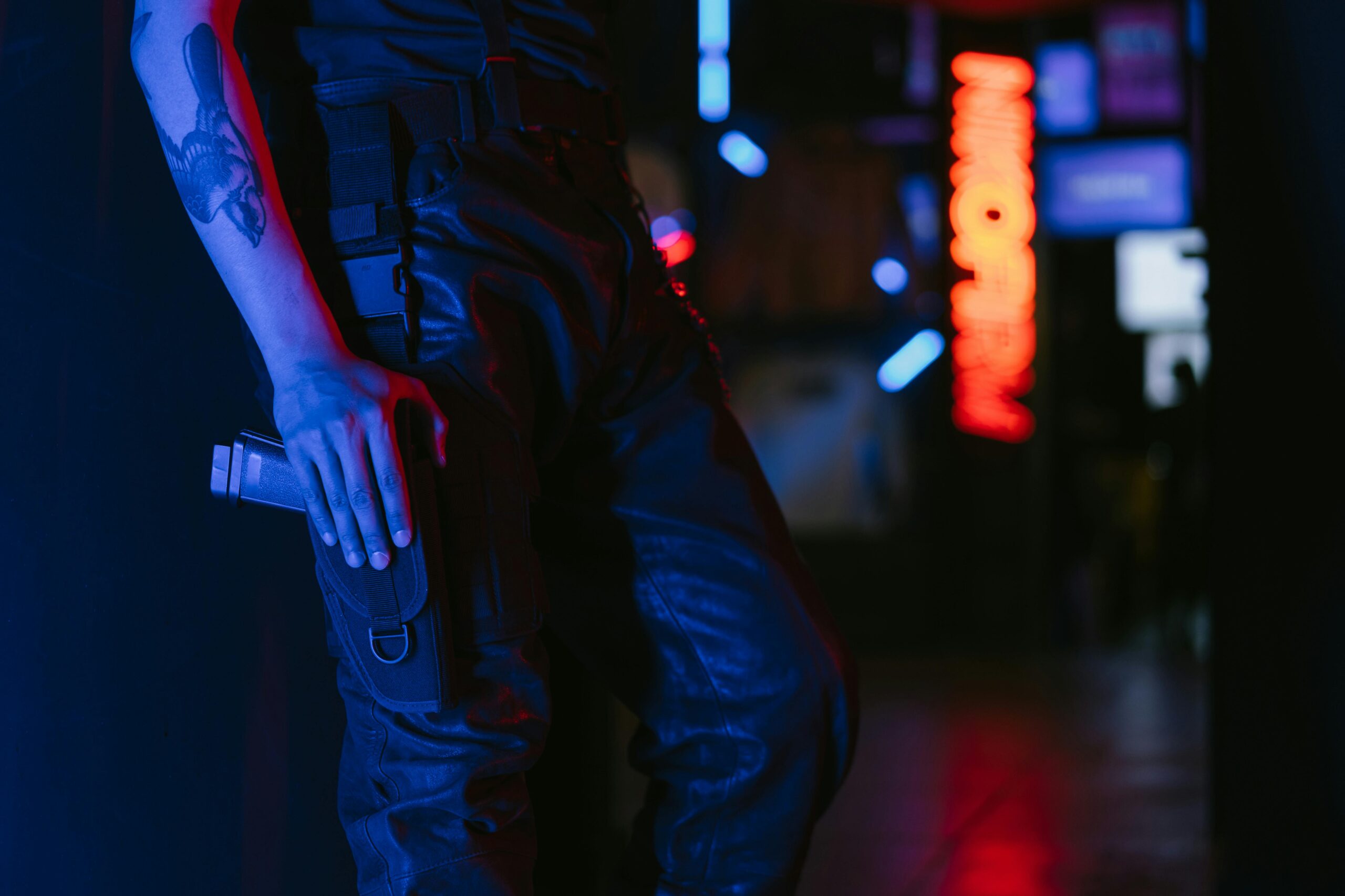A Person with Arm Tattoo Holding a Gun in Pocket